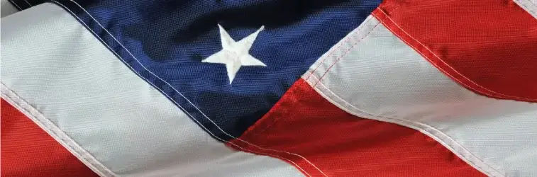 United States flag showing blue field with white stars and red and white stripes.