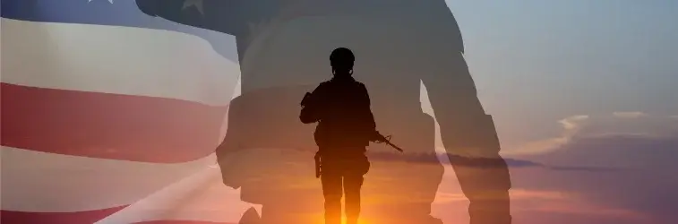 Overlaid of a waving American flag in the background with soldiers silhouettes