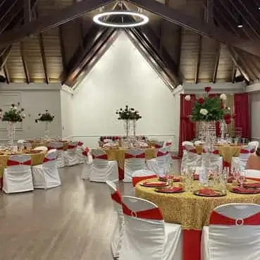 Hall rental wedding reception with red and gold theme.